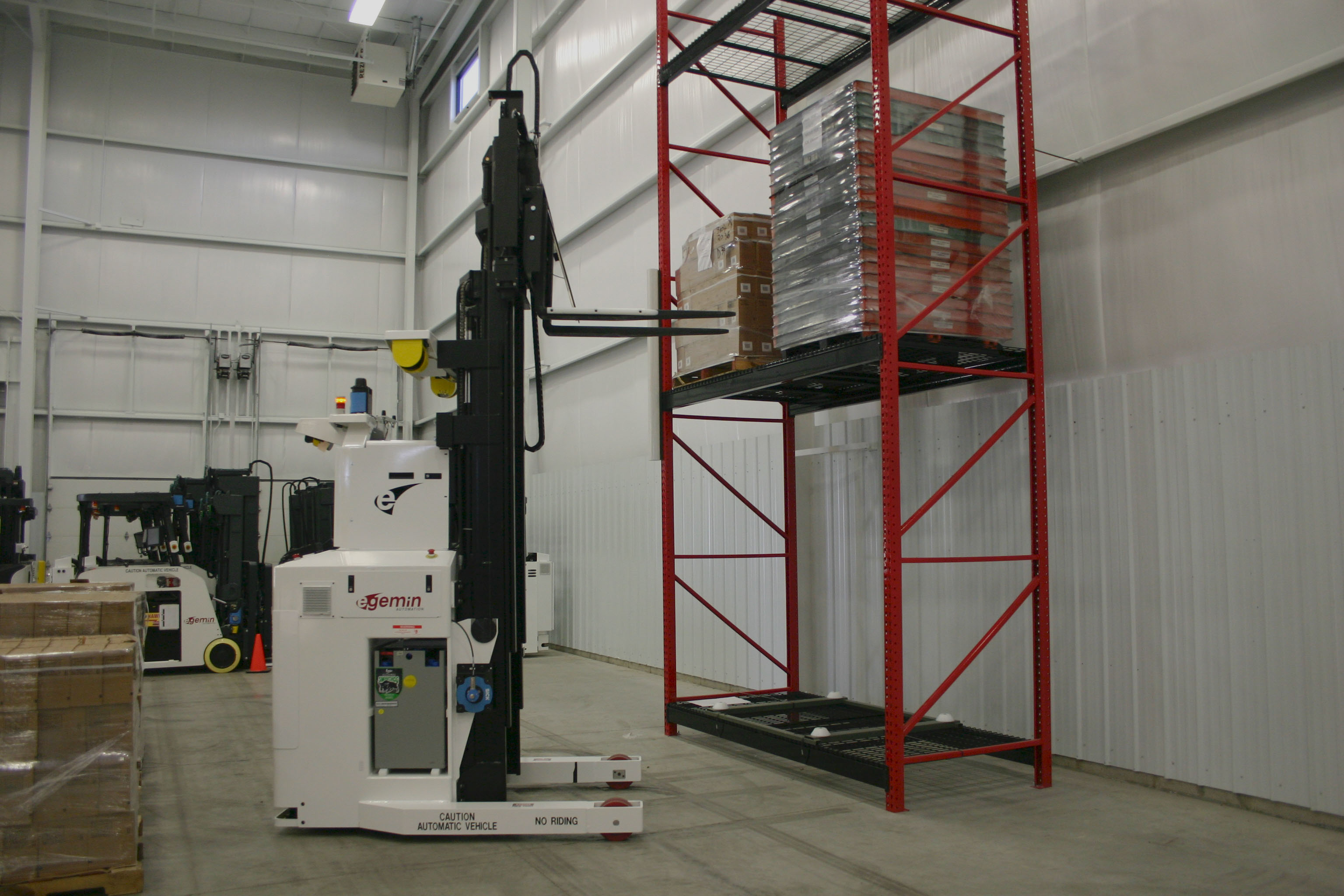 Autonomous forklift navigating a modern warehouse